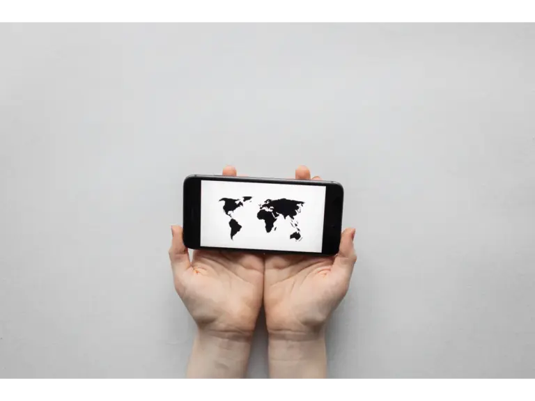 Hands holding a smartphone displaying a world map on a white background, illustrating an AI planned travel experience with a clean, modern look