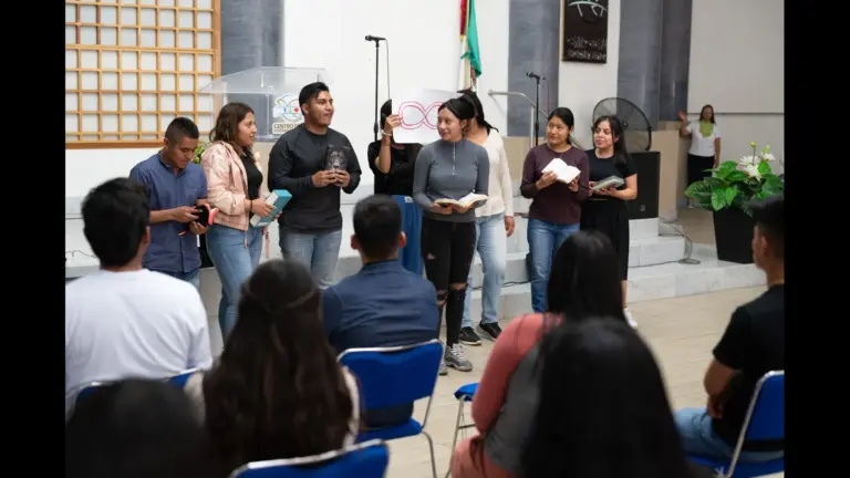 In daily devotional, several people are standing up holding Bibles reading and proclaiming their faith.