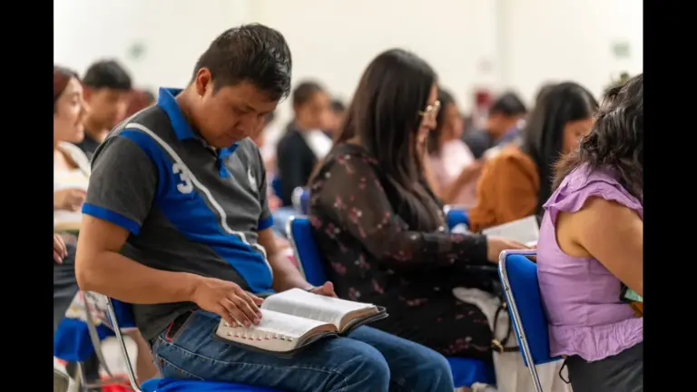 In daily devotional, people are studying the Bible in a classroom setting.