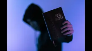 In this daily devotional, someone boldly holds up the Bible for all to see.