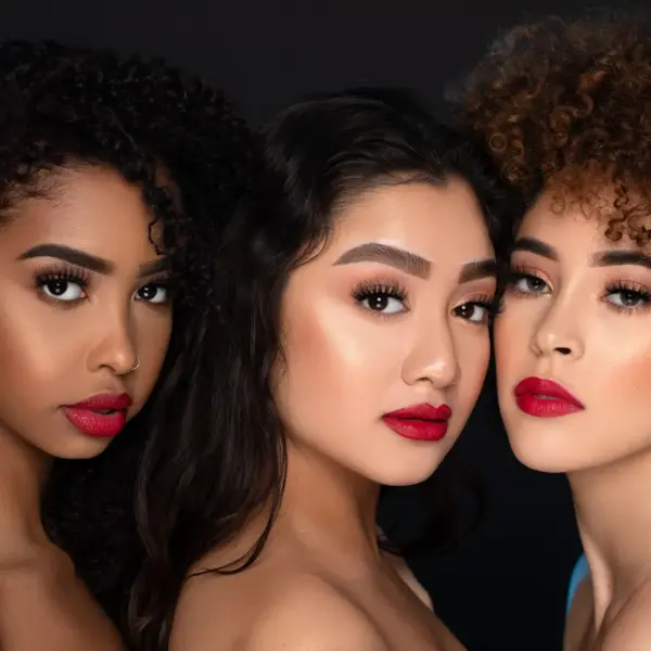Close‑up portrait of diverse women with striking red lips, emphasizing beauty, confidence, and the subtle makeup tricks that make every feature stand out.