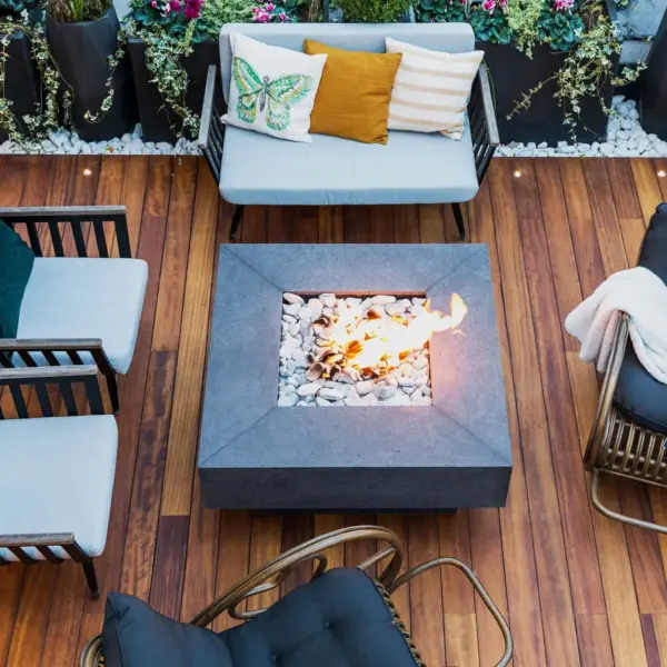 A top‑down view of a modern patio featuring stylish furniture and a central firepit, creating a clean, inviting space perfect for DIY Projects.