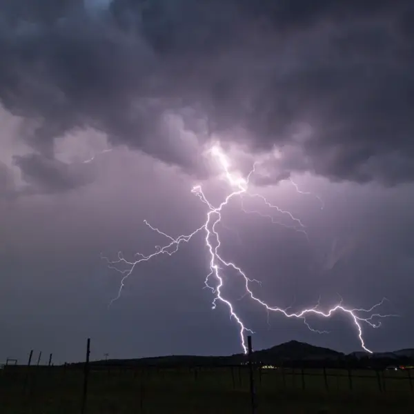 Stunning capture of a powerful lightning storm, glowing with raw atmospheric energy that mirrors the intense, instinctive pull of weather intuition.