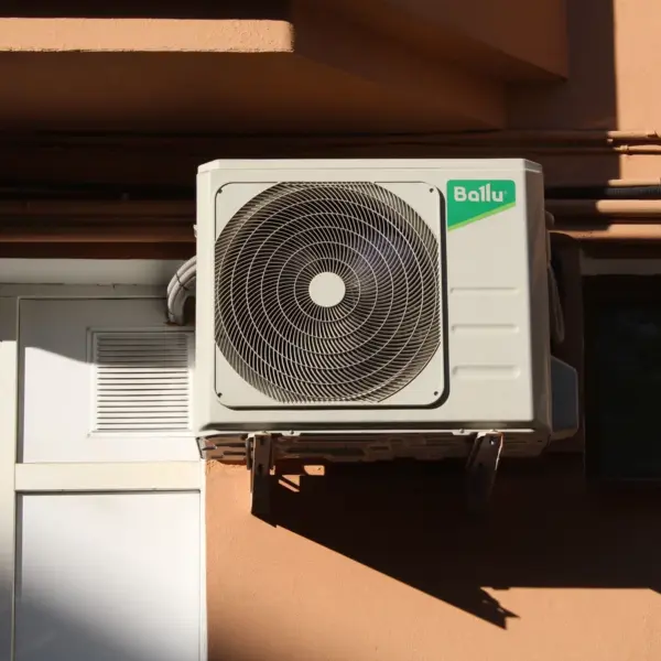 A Ballu air conditioner condenser unit mounted on a building exterior, highlighting efficient home cooling technology.