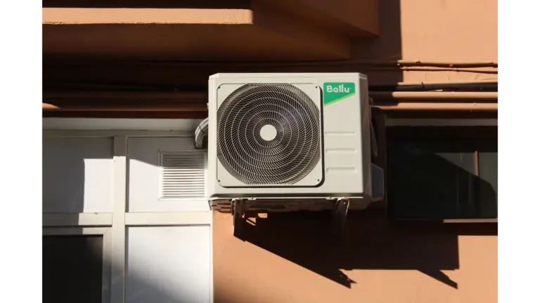 A Ballu air conditioner condenser unit mounted on a building exterior, highlighting efficient home cooling technology.