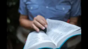 In daily devotional, a person reads/studies the Bible.