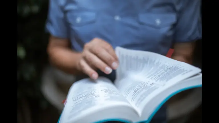 In daily devotional, a person reads/studies the Bible.