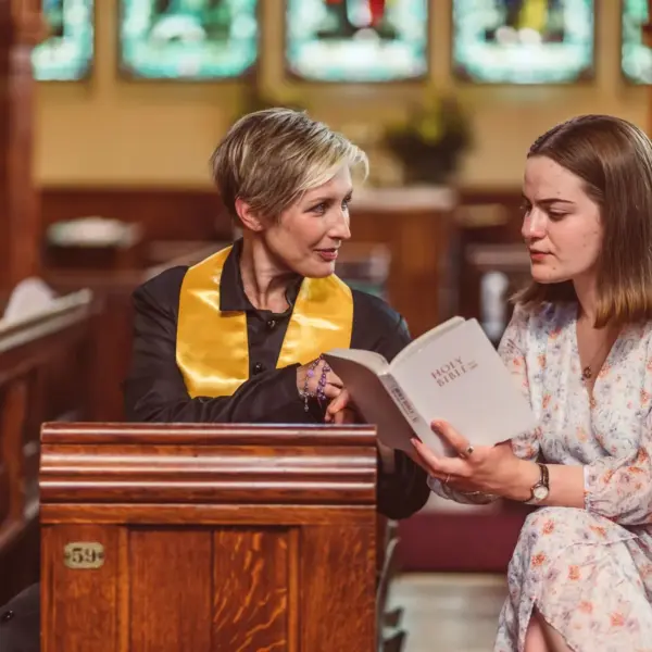 In Monday's daily devotional, a minister speaks to a woman privately in a church.
