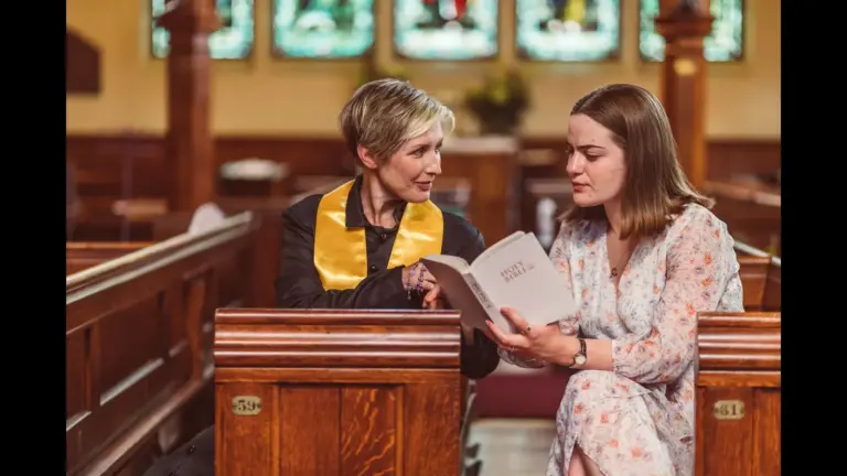 In Monday's daily devotional, a minister speaks to a woman privately in a church.