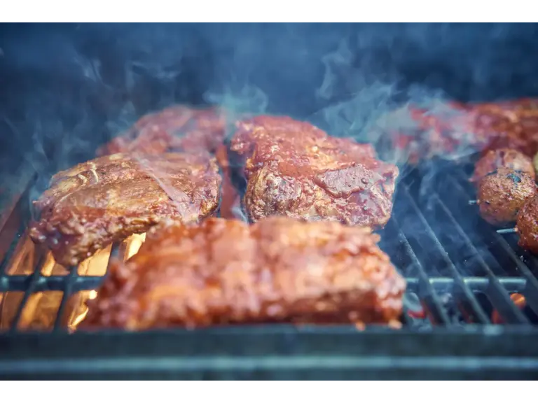 tasty barbecue smoked ribs sizzling on the grill, perfect for summer gathering