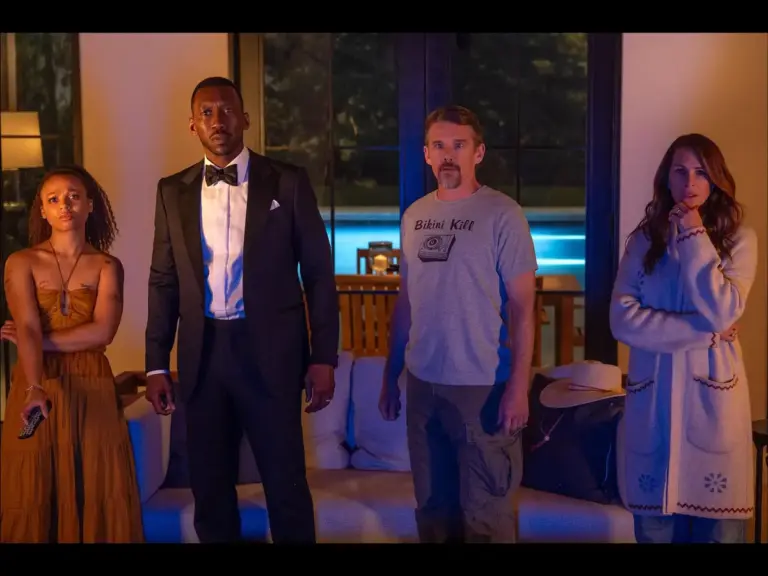 The cast of Leave The World Behind poses together, showcasing their characters in a dramatic setting.