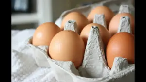 A carton containing eight brown eggs. Breakfast