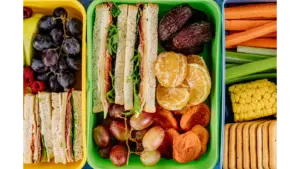 Colorful lunchbox filled with sandwiches, fresh fruits, and vegetables, perfect for a healthy meal and ideal for easy school lunches.