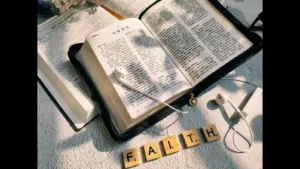 In Friday's daily devotional, an open Bible sits with earplugs and the word "faith" spelled out in letters