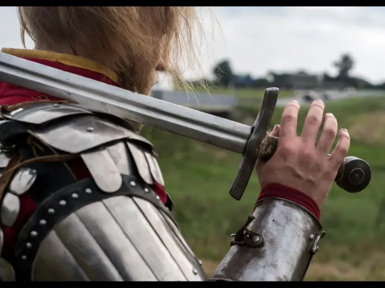 In Monday's daily devotional, a soldier stands ready to defend his territory against the enemy's forces in full battle gear.