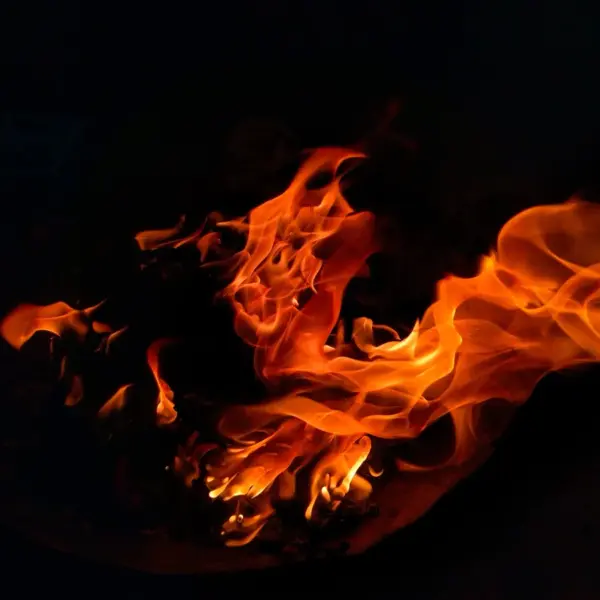 A mesmerizing view of flames dancing in the dark, creating warmth and light, echoing the surreal intensity of fire dreams.