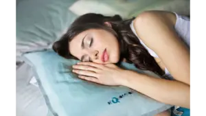 Dream symbolism is reflected as a woman peacefully sleeps on a soft pillow, capturing the essence of comfort and relaxation indoors.