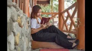 In Tuesday's daily devotioinal, a young woman reads the Bible intently as she relaxes in a home nook.