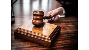 Close-up of a wooden gavel on a judge's desk, symbolizing justice for Jay Lee