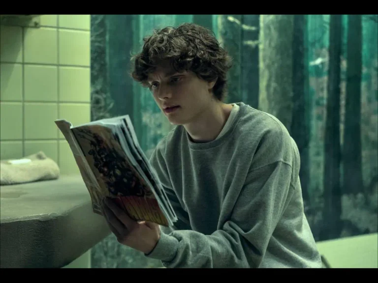 Asa Germann in Gen V in a scene reading a what looks like to be a comic book
