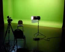 Green screen studio with a camera and lights, the kind of set where Apple Studios VFX crews work