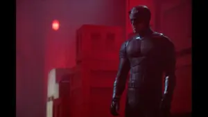 "Daredevil: Born Again" by Marvel Television Charlie Cox as Daredevil in a dark scene, illuminated by a striking red light.