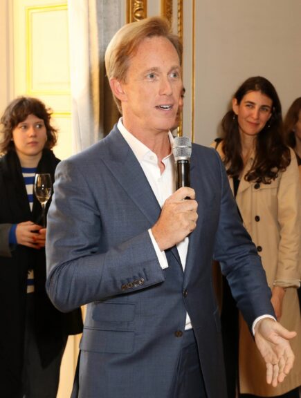 Roger Lynch, the incoming Mattel CEO, speaks into a microphone at a 2019 Paris Fashion Week event