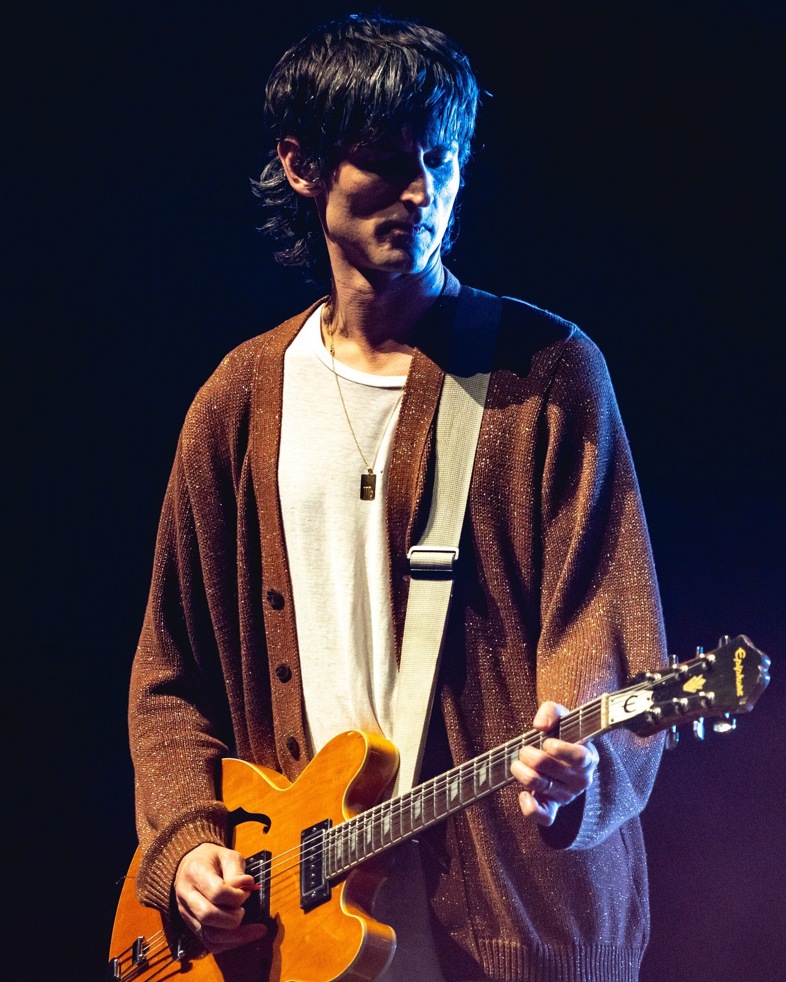 Nick Valensi plays guitar onstage with The Strokes during a New Year's Eve 2019 concert