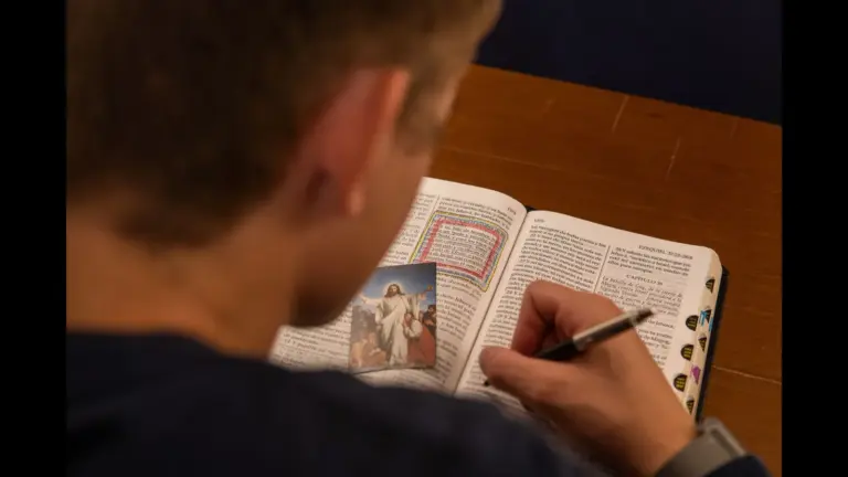 In Wednesday's daily devotional, a man studies the Bible while underlining verses.