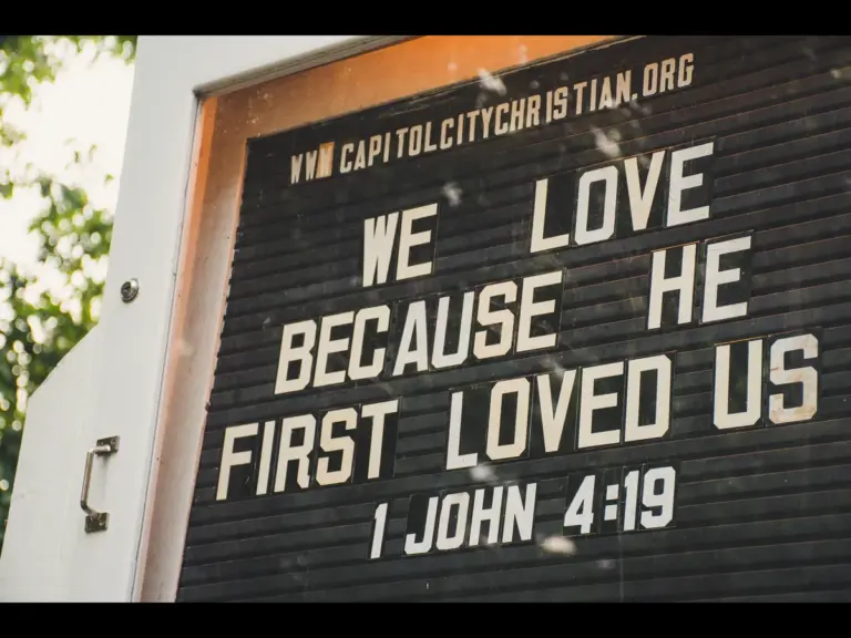 In Tuesday's daily devotional, a church marquee says, "We love because He first loved us."