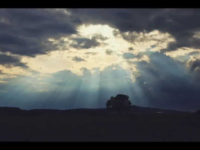 In Tuesday's daily devotional, a dark sky is seen with clouds and opening revealing God's light. 