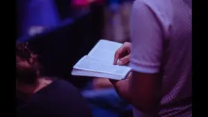 In Monday's daily devotional, people read Scripture in a Bible class.
