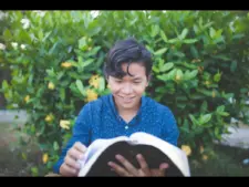 In Tuesday's daily devotional, a young man studys the Word eagerly.