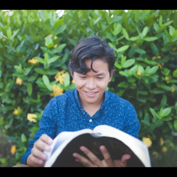 In Tuesday's daily devotional, a young man studys the Word eagerly.