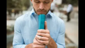 In today's daily devotional, a man holds the Bible close to him and closes his eyes in humility and gratitude.