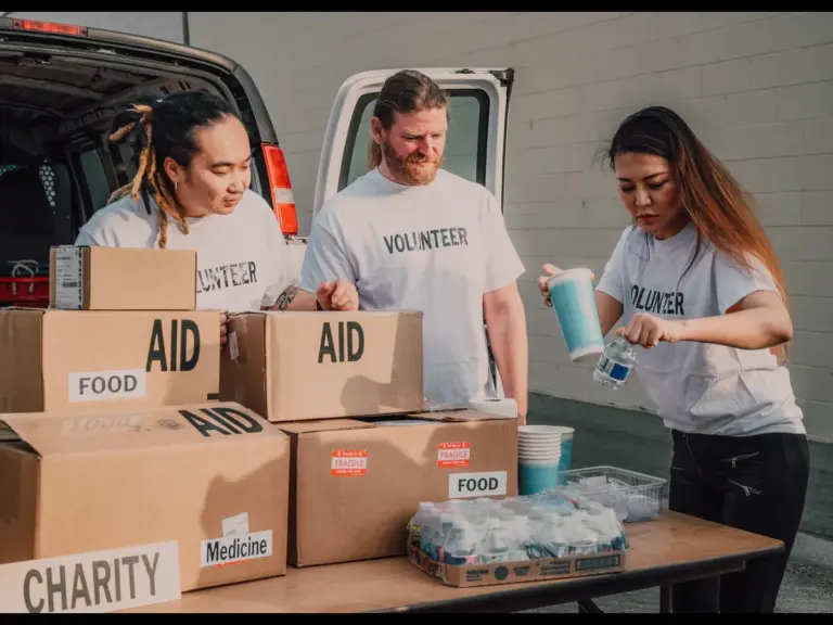 In Thursday's daily devotional, three volunteers prepare to give out aid to people.