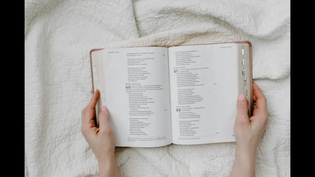 In Friday's daily devotional, a woman's hands are shown holding an open Bible as if reading or studying.
