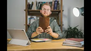 In Tuesday's daily devotional, a man holds up his Bible, as it looks like his study time.