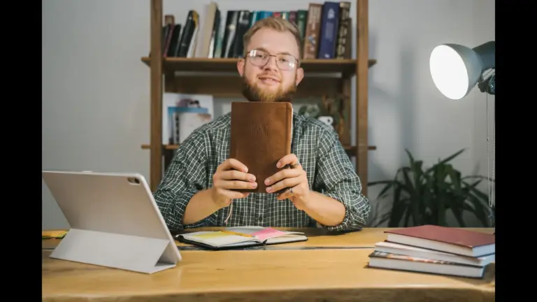 In Tuesday's daily devotional, a man holds up his Bible, as it looks like his study time.