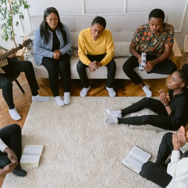 In Tuesday's daily devotional, a group Bible study plays a a guitar and sings unto the Lord.