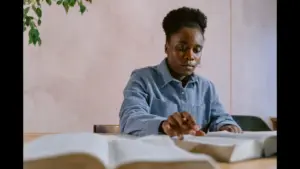 In Friday's daily devotional, a woman sits at a table studying the Bible.