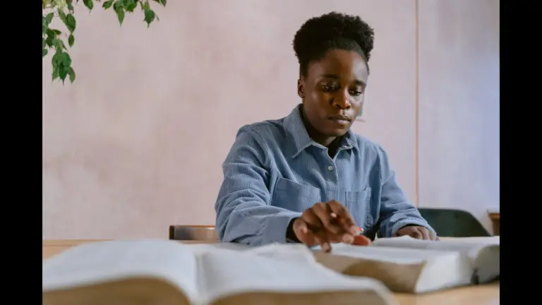 In Friday's daily devotional, a woman sits at a table studying the Bible.