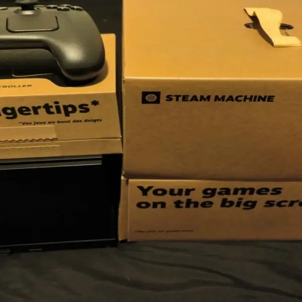 Steam Machine and Steam Controller with boxes that say "Your games on the big screen, at your fingertips."