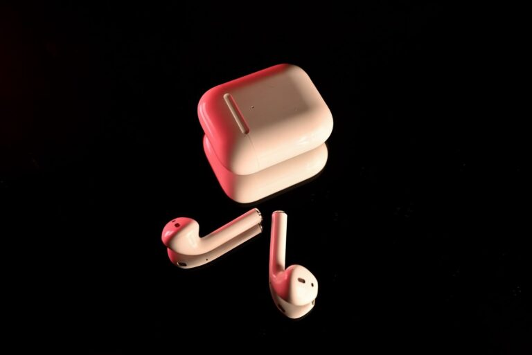 White true wireless earbuds and charging case on a black background, the type of product AVIOT is selling as the 96Neko earbuds