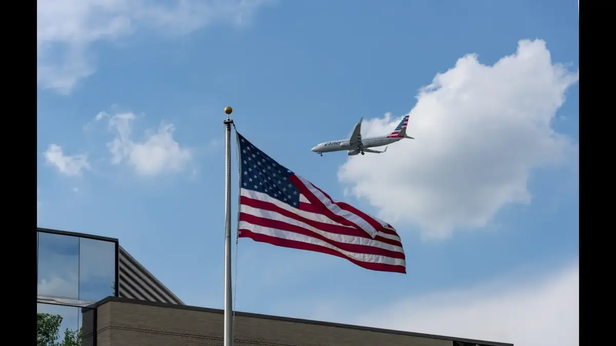 Boeing 737 of American Airlines at John Glenn Columbus International Airport behind an American flag.