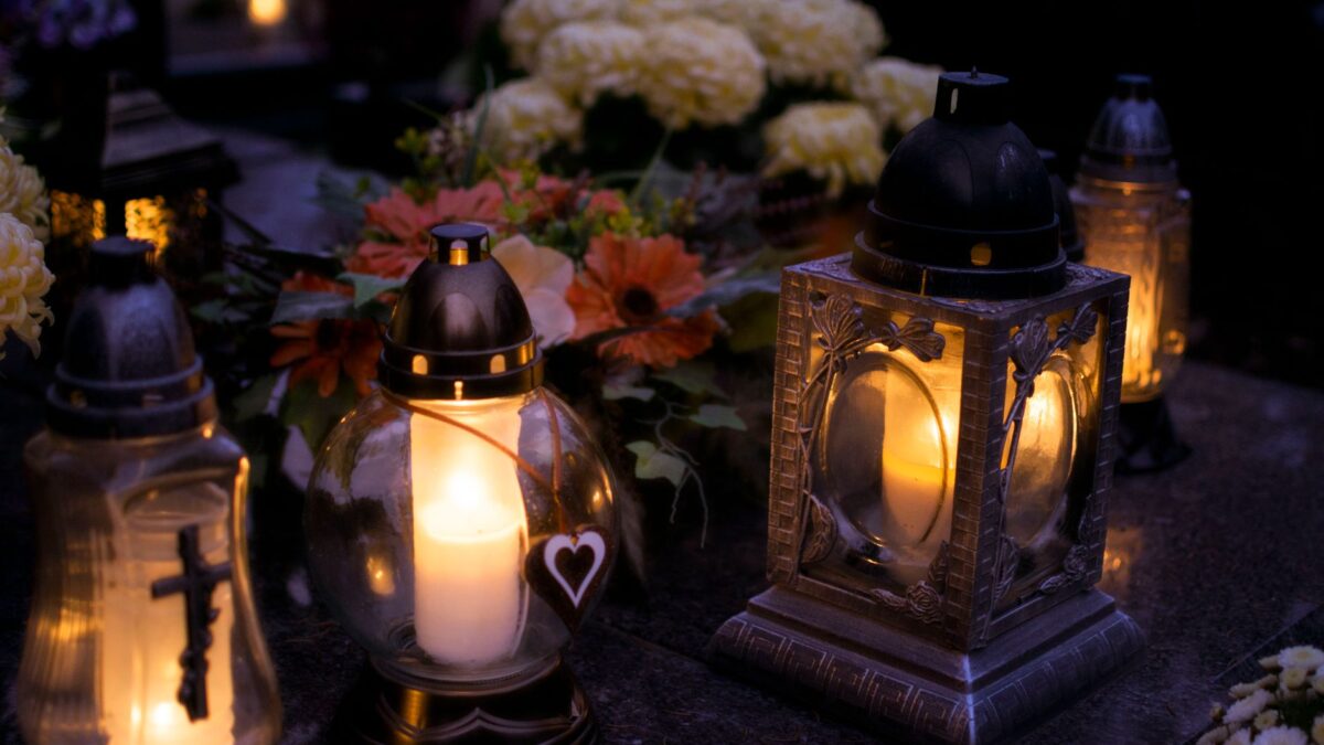Cemetery lanterns glowing at night for All Saints' Day