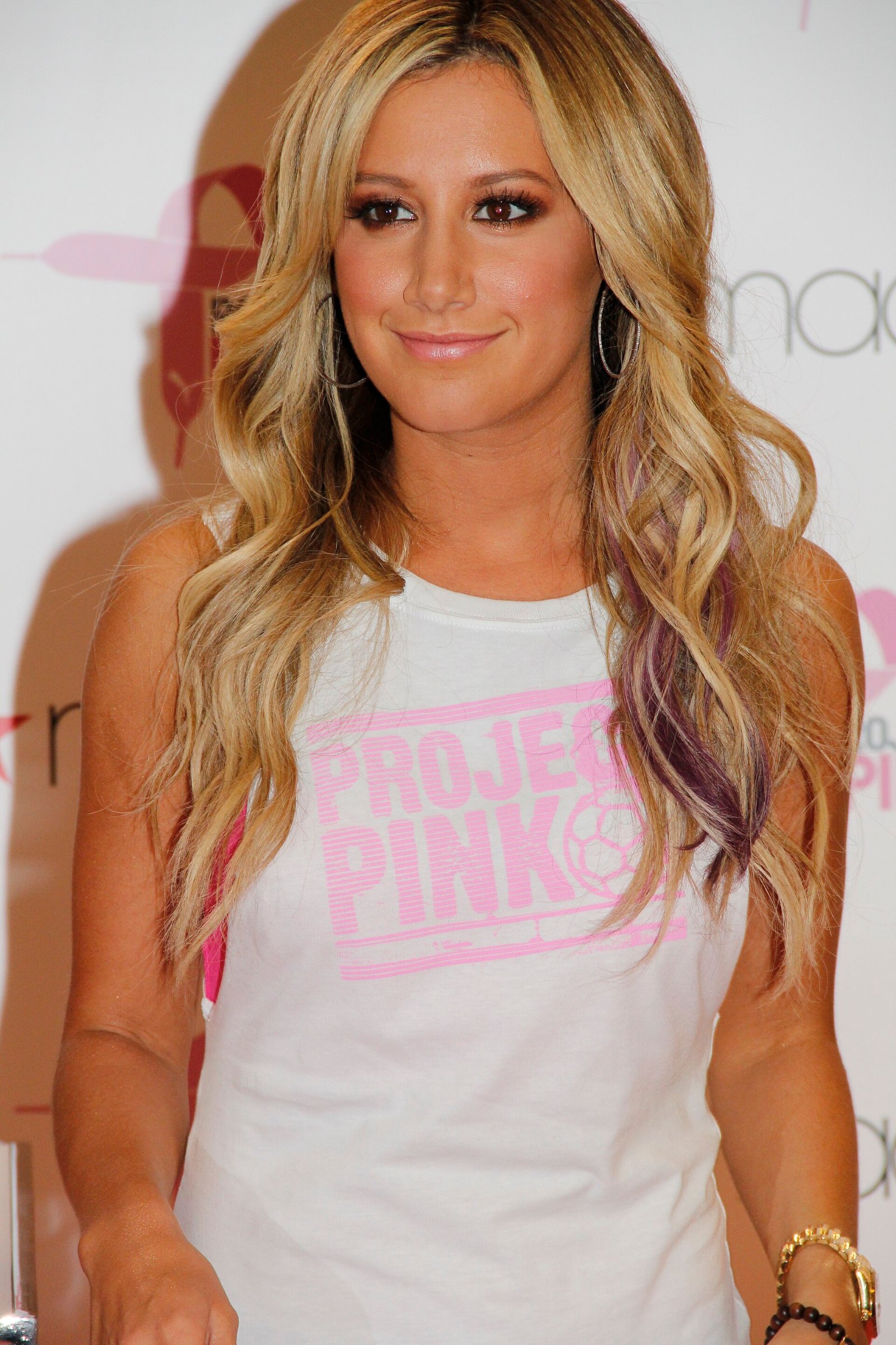 Ashley Tisdale smiles at a Puma Project Pink event in New York in 2012, years before her toxic mom group essay