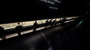 Visitors view the Bayeux Tapestry in a darkened British Museum gallery, the exhibition at the center of a Bayeux Tapestry lawsuit over audio description