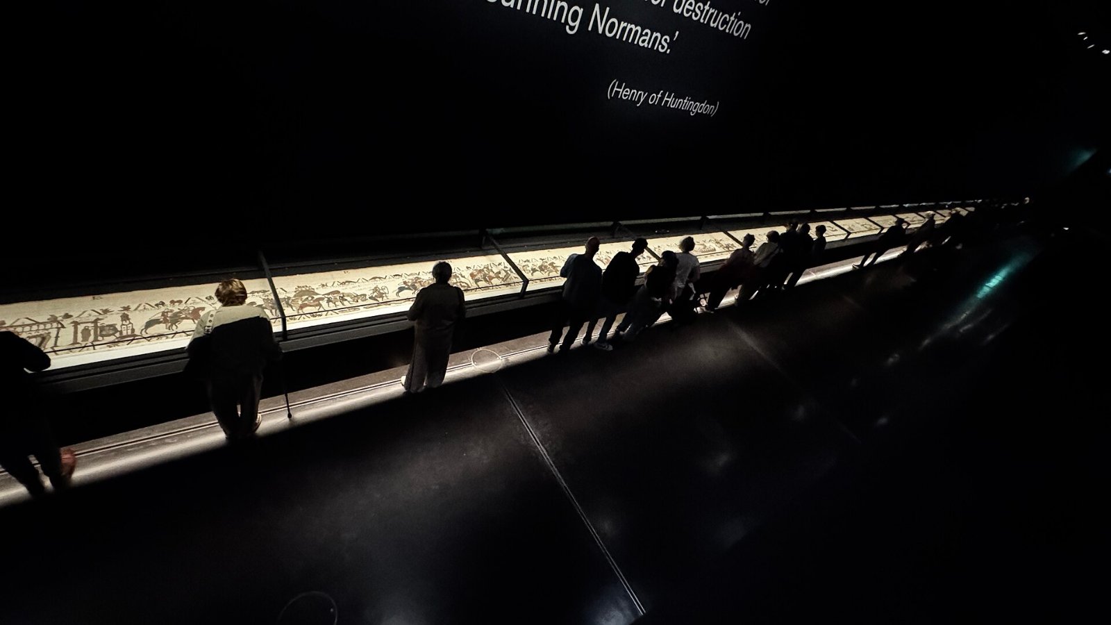 Visitors view the Bayeux Tapestry in a darkened British Museum gallery, the exhibition at the center of a Bayeux Tapestry lawsuit over audio description