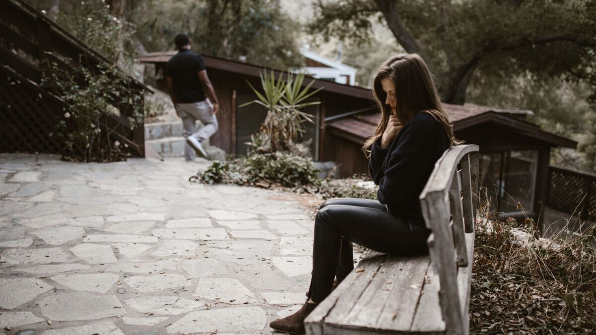 Woman on a bench reflecting during Breakup recovery